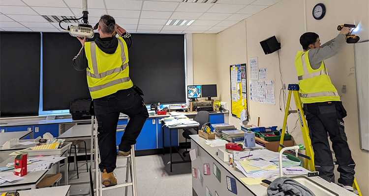 Gateway Heyworth Engineers installing a projector.